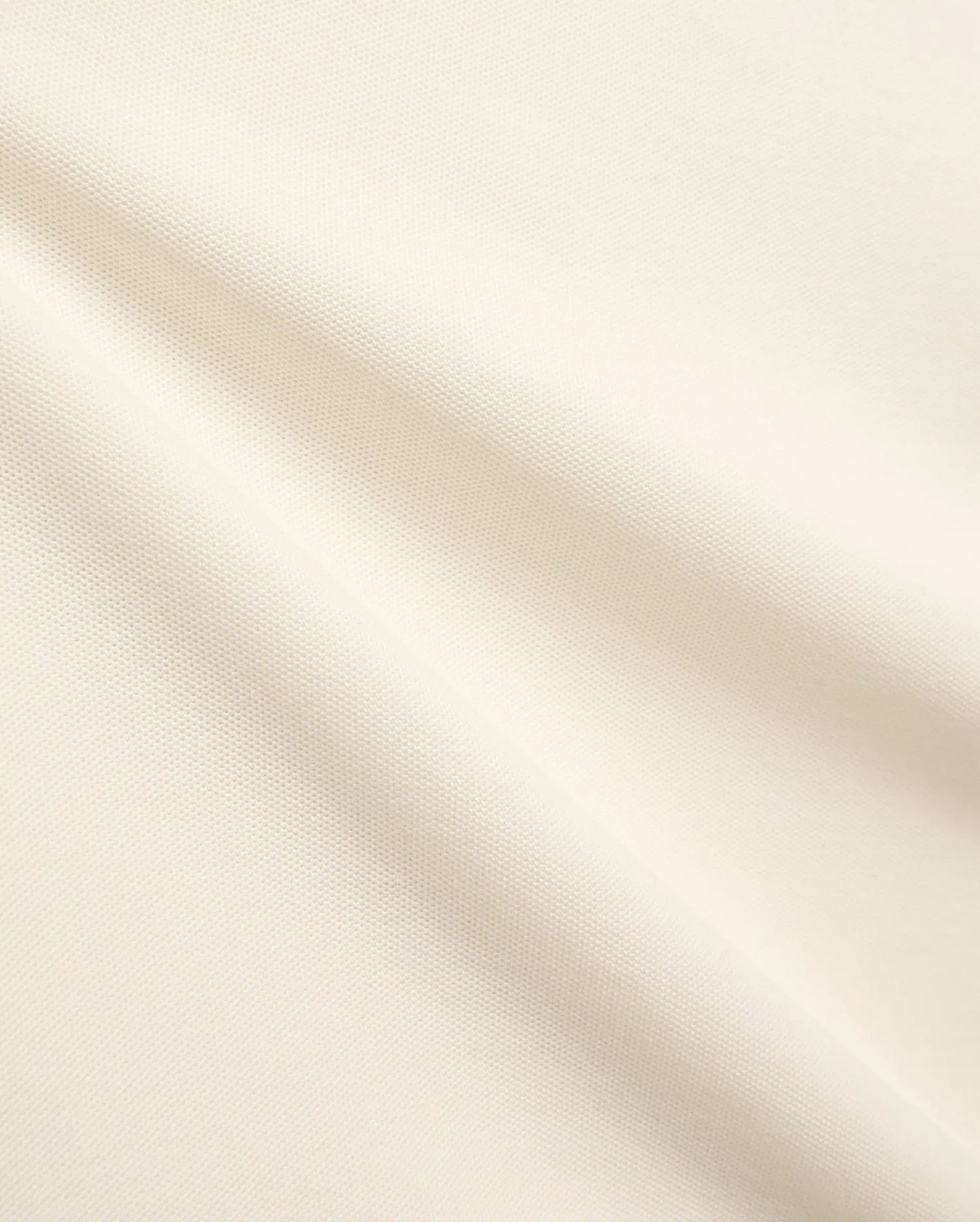 Kids Sunny Pique Polo, a creamy off-white shirt crafted from textured pique fabric, featuring the signature small embroidered Psycho Bunny skull logo on the left chest.