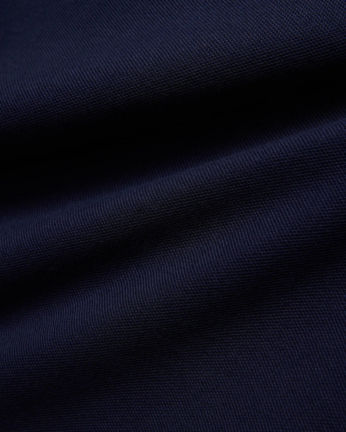 KIDS JAYDON PIQUE POLO in a deep, luxurious navy blue, showcasing the intricate, breathable texture of its premium pique knit fabric, a hallmark of Psycho Bunny's refined quality.