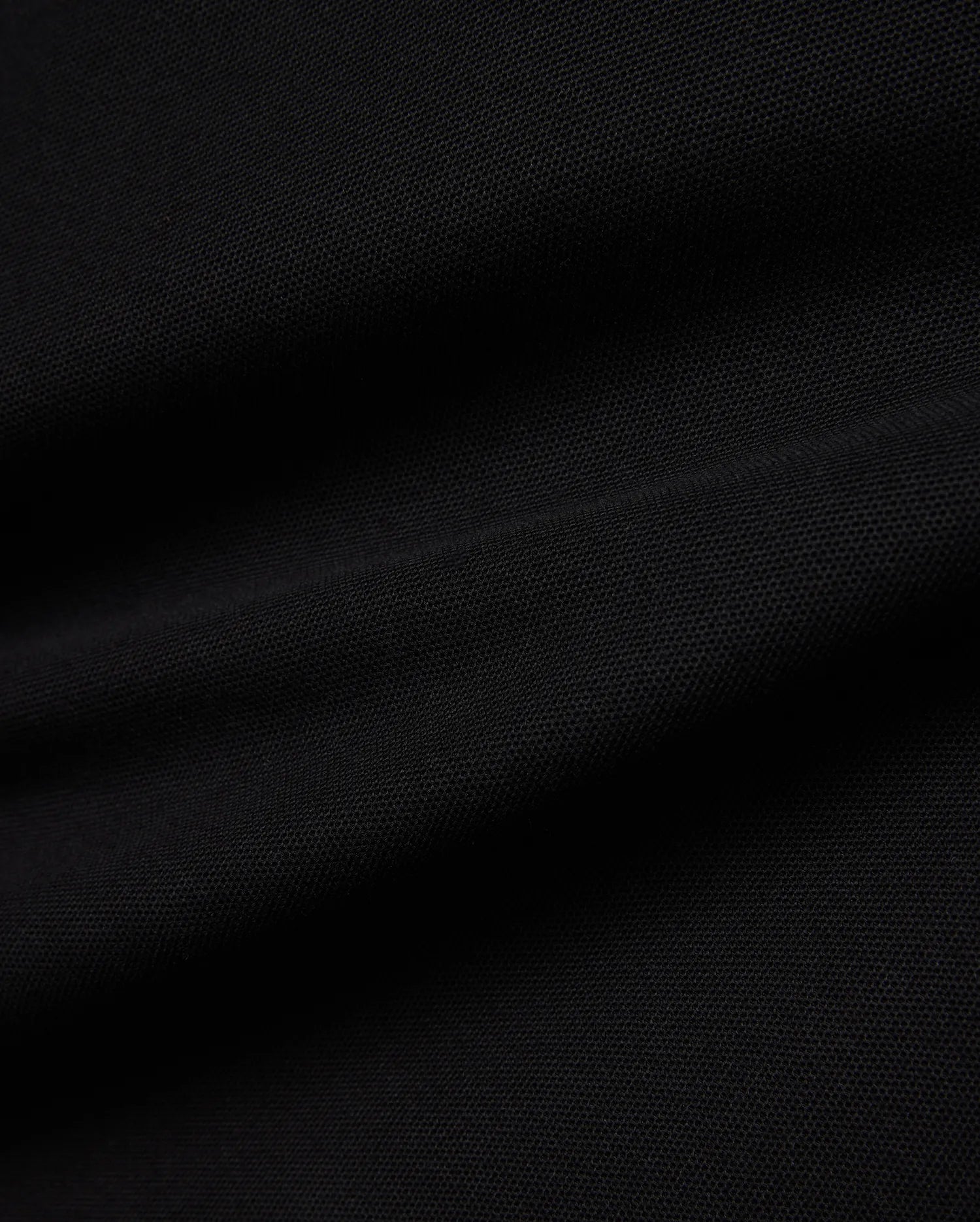 Kids Jaydon Pique Polo in deep black, showcasing its premium textured pique fabric, designed for a classic fit, and featuring the signature small embroidered Psycho Bunny skull logo on the left chest.