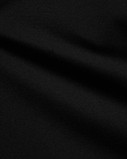 Psycho Bunny Kids Stan Pique Polo in deep black, showcasing the premium, breathable pique knit fabric with a subtle texture, perfect for refined streetwear.