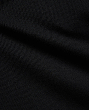 Psycho Bunny Kids Stan Pique Polo in deep black, showcasing the premium, breathable pique knit fabric with a subtle texture, perfect for refined streetwear.