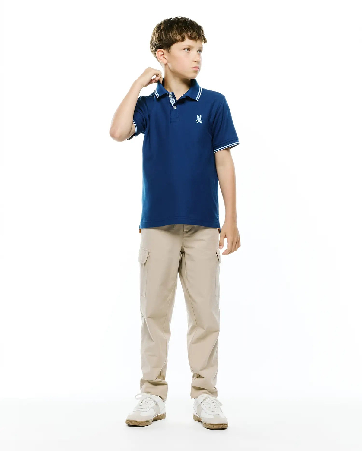 Kids Stan Pique Polo in navy blue, featuring a classic fit, pique knit fabric, ribbed collar and cuffs with white double stripes, and a small embroidered white Psycho Bunny skull logo on the left chest.