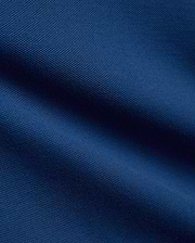 Kids Stan Pique Polo in a rich, dark navy blue, showcasing the classic, breathable textured pique knit fabric with subtle, elegant folds and shadows across its surface.