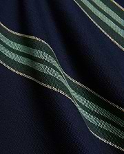 Kids Drew Striped L/S Pique Polo in navy, featuring a textured pique knit fabric with bold horizontal stripes in dark green, mint green, and thin beige accents. (6)