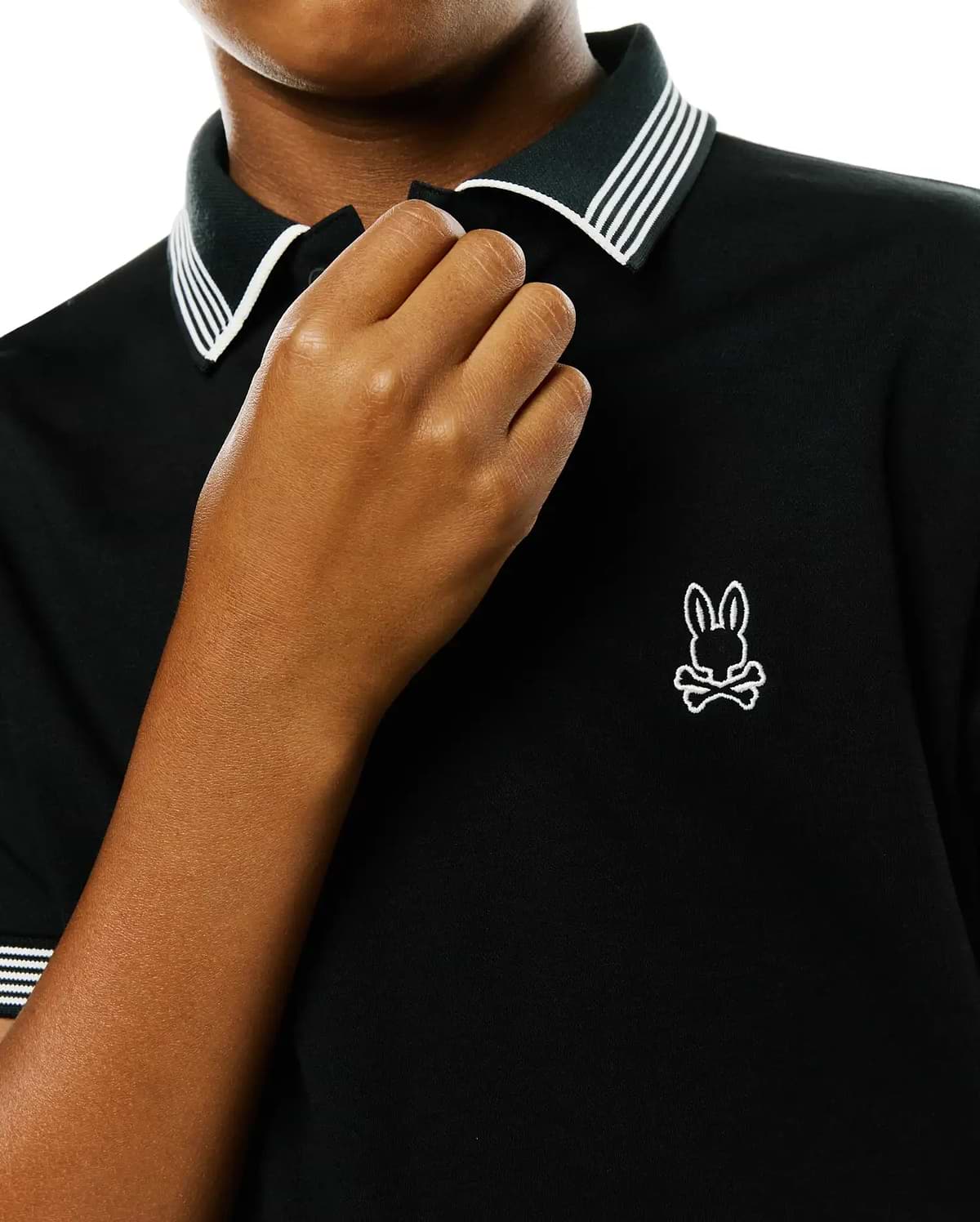 Kids Timmy Pique Polo, a black classic fit pique polo shirt with a ribbed collar and cuffs featuring crisp white stripes, accented by a small, embroidered white Psycho Bunny skull logo on the left chest.