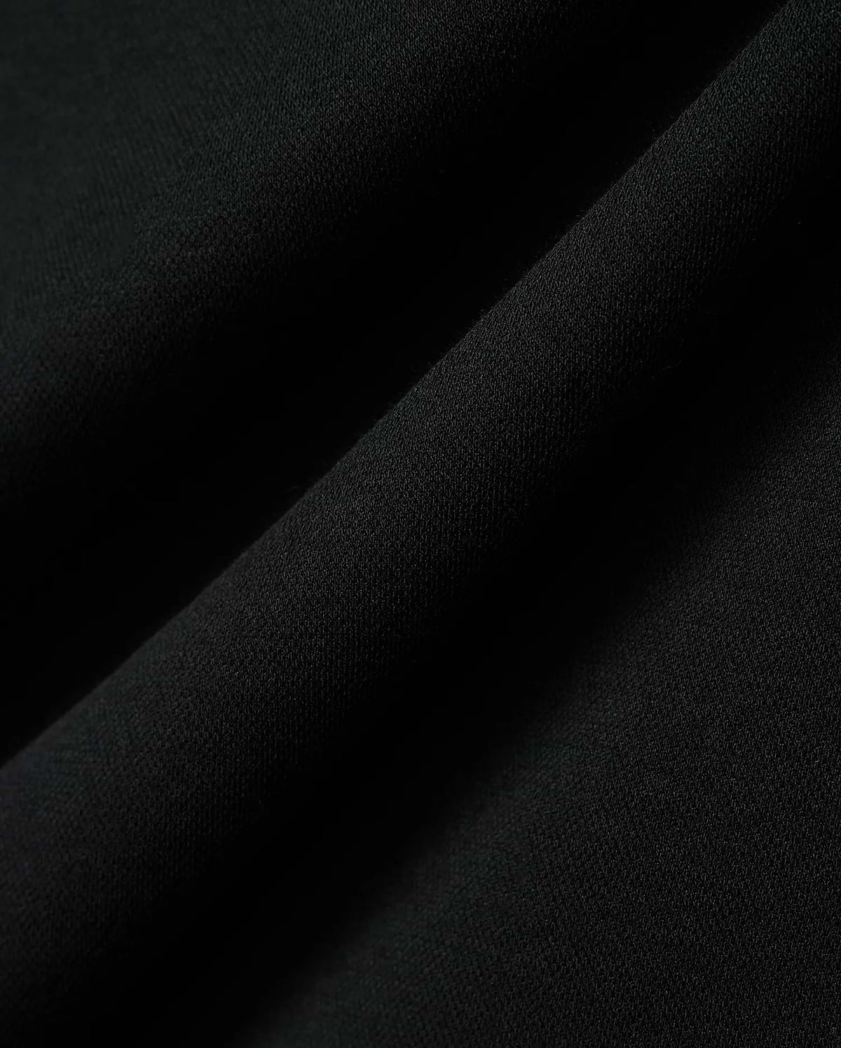 Kids Timmy Pique Polo in classic black, featuring a premium, finely textured pique knit fabric with soft, flowing folds, embodying Psycho Bunny's signature style.
