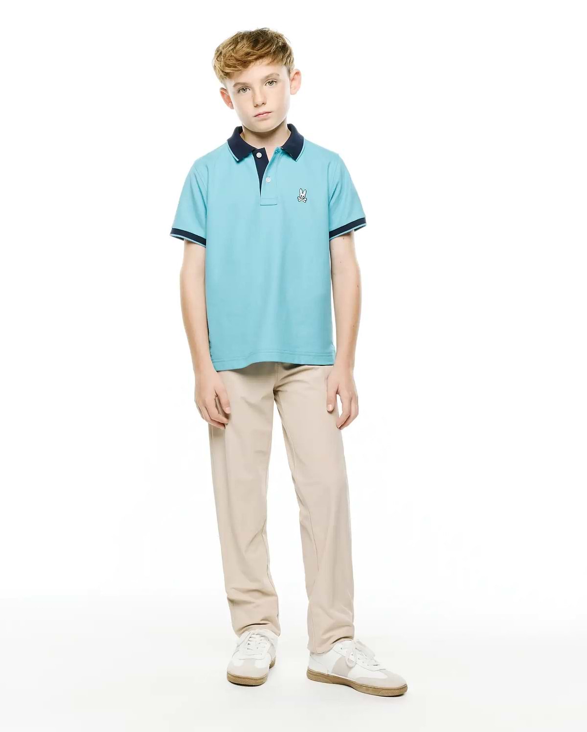 Kids' Klaus Pique Polo, a light blue classic fit pique knit polo with navy collar and sleeve cuffs, featuring a small embroidered Psycho Bunny logo on the left chest. (4)