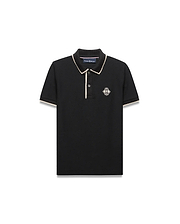 Kids Robin Pique Polo, black classic fit pique with cream piping on collar and sleeves, featuring an embroidered Psycho Bunny skull logo in a diamond on the left chest.