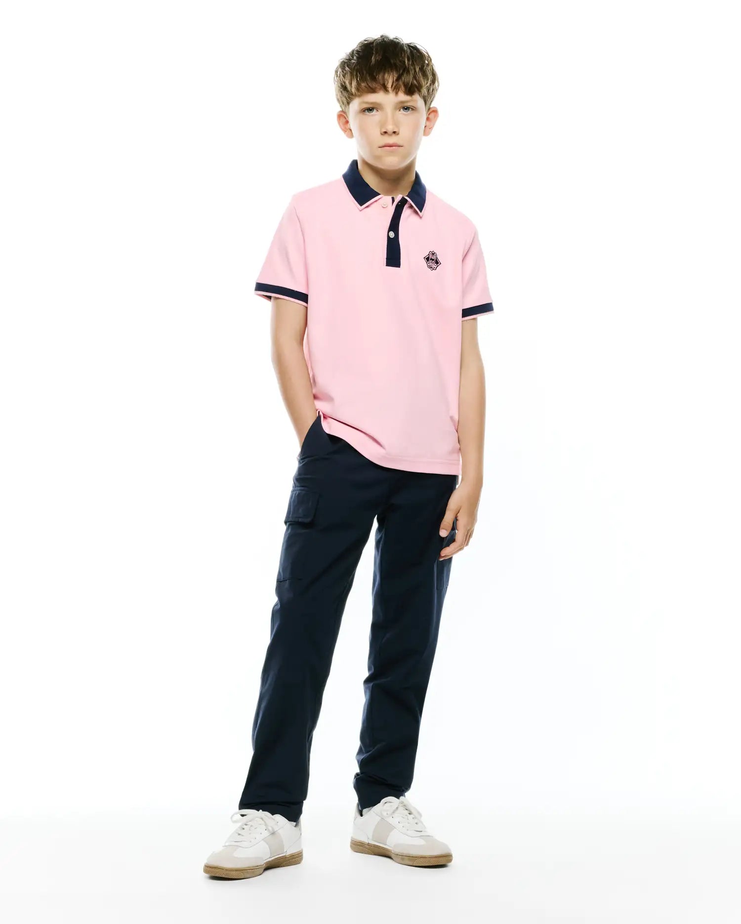 Kids Robin Pique Polo in light pink, featuring a classic fit, navy blue tipped collar and sleeve cuffs, and a small embroidered Psycho Bunny skull logo on the left chest.