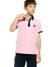Kids Robin Pique Polo in light pink, featuring a classic fit, navy blue ribbed collar and cuffs, two-button placket, and a small embroidered Psycho Bunny skull logo on the left chest.