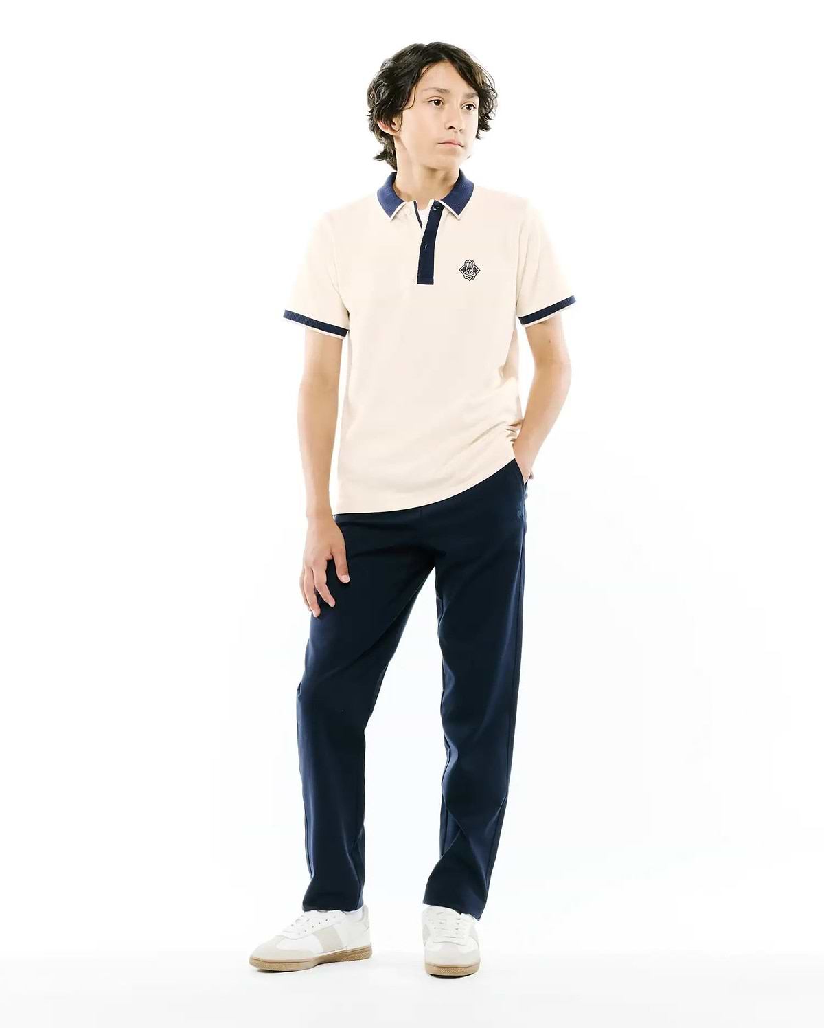 Kids Robin Pique Polo in cream pique with navy blue ribbed collar, two-button placket, and cuffs. Features a small embroidered Psycho Bunny skull logo on the left chest, classic fit.