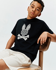 Kids Brad Graphic Tee, black cotton jersey, classic fit, featuring a large white Psycho Bunny skull and crossbones graphic with intricate palm tree and scale patterns, and a small blue hem tag.
