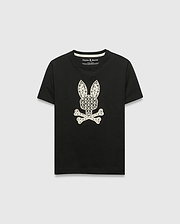 Kids Brad Graphic Tee, black jersey t-shirt with a large white Psycho Bunny skull and crossbones graphic on the chest, featuring a pattern of small bunny logos and palm trees. Classic fit.