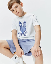 White Kids Brad Graphic Tee, classic fit jersey, with a large blue and white palm tree patterned Psycho Bunny skull and crossbones logo on the center chest.