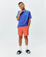 Kids Sunny Chest Graphic Tee, royal blue jersey with small white embroidered Psycho Bunny skull logo on left chest. Coral woven shorts with embroidered bunny logo on left leg, classic fit.