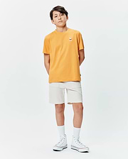 Orange Kids Sunny Chest Graphic Tee in classic fit jersey, featuring a small embroidered Psycho Bunny skull logo on the left chest, paired with off-white woven shorts.