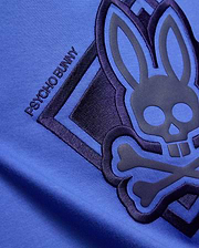 Kids Tobias Graphic Tee in vibrant blue jersey knit, featuring a large dark navy embroidered and raised Psycho Bunny skull logo with PSYCHO BUNNY text.