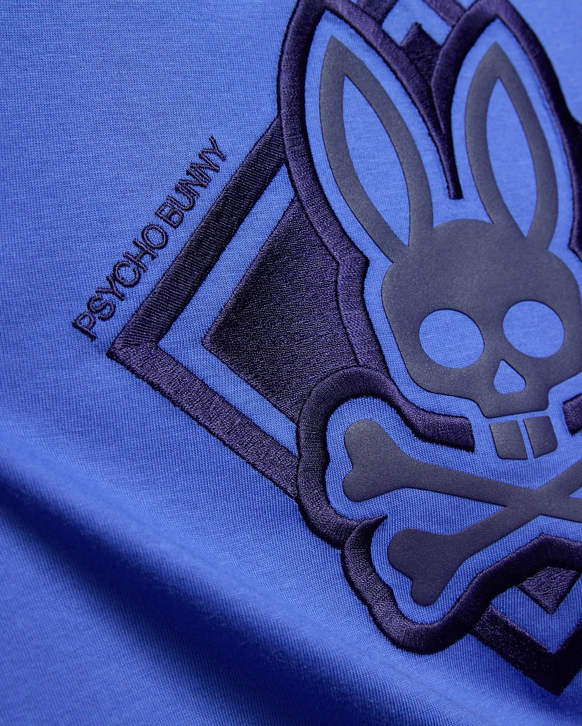 Kids Tobias Graphic Tee in vibrant blue jersey knit, featuring a large dark navy embroidered and raised Psycho Bunny skull logo with PSYCHO BUNNY text.