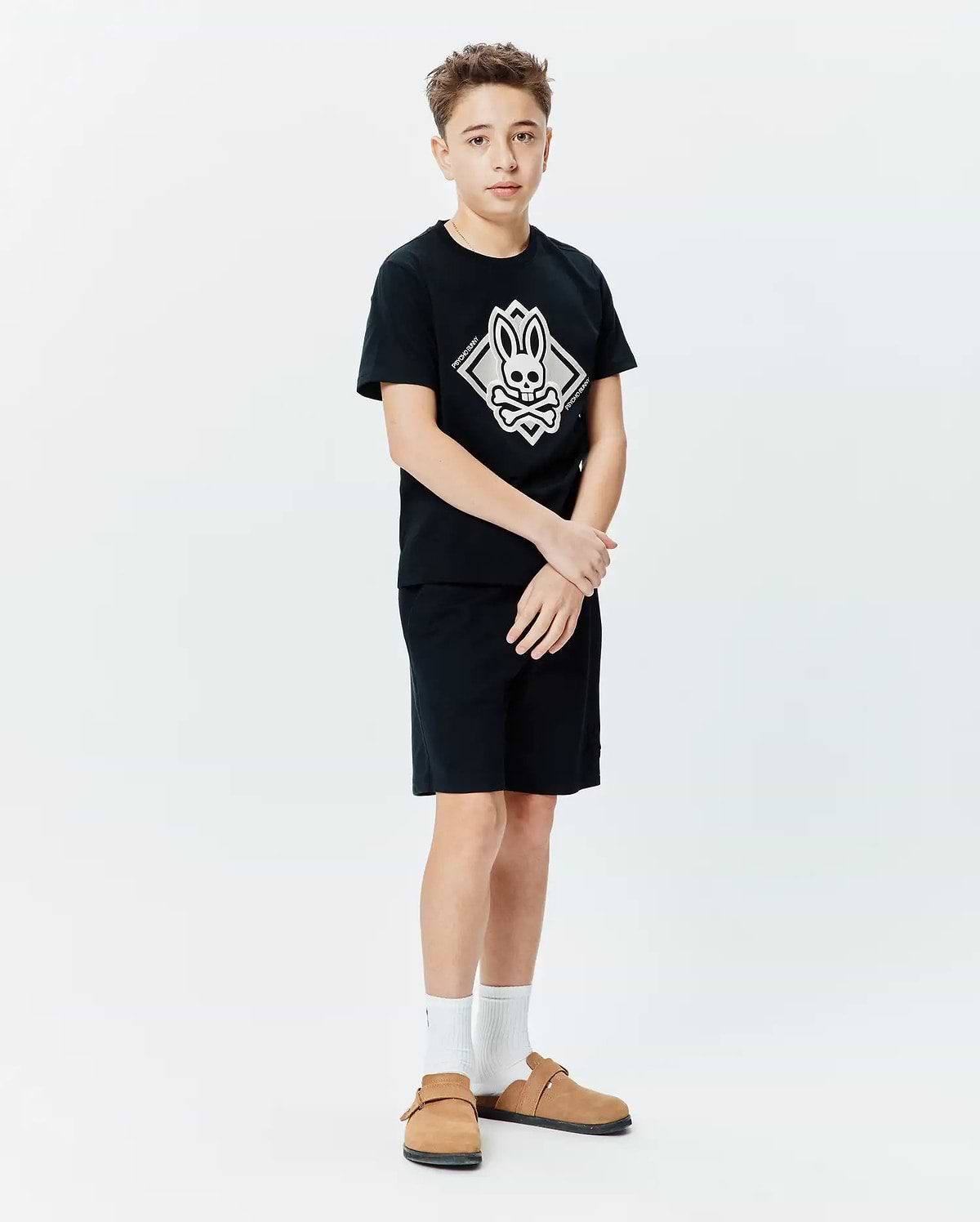 Kids Tobias Graphic Tee, black jersey knit, classic fit, featuring a large central white and grey Psycho Bunny skull and crossbones diamond graphic with vertical brand name.