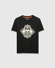 Kids Tobias Graphic Tee, black classic fit jersey t-shirt with a large central white bunny skull and crossbones graphic inside a diamond, flanked by Psycho Bunny text, and an orange inner neckline trim.