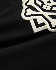 Kids Tobias Graphic Tee: Black jersey t-shirt with a large, prominent white embroidered and printed Psycho Bunny skull and crossbones logo on the chest.