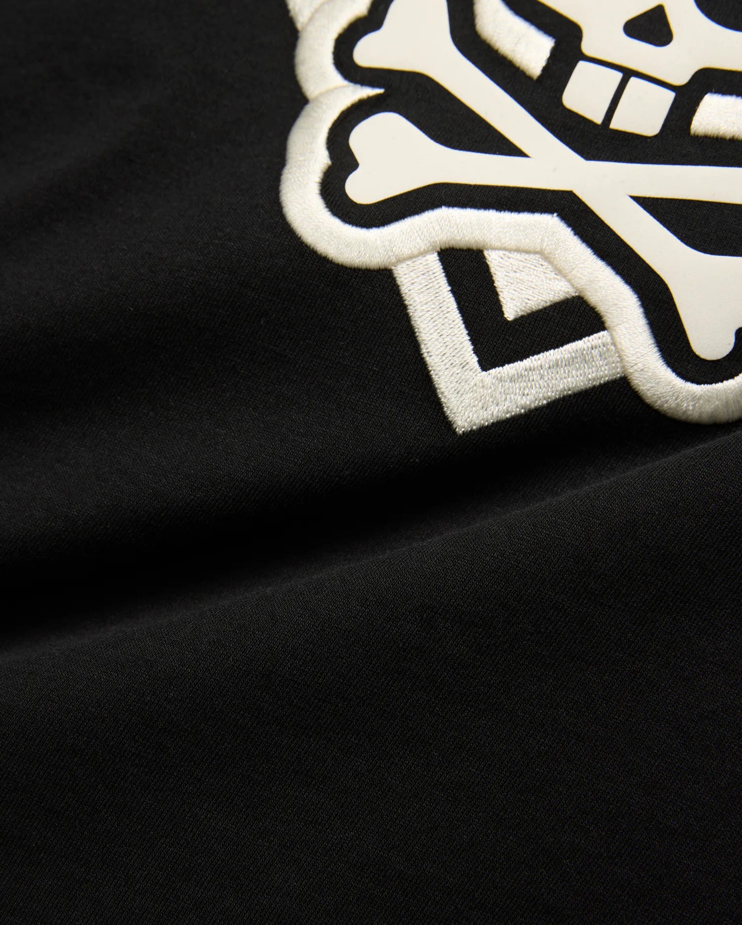 Kids Tobias Graphic Tee: Black jersey t-shirt with a large, prominent white embroidered and printed Psycho Bunny skull and crossbones logo on the chest.