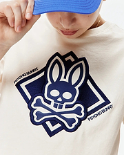 Kids Tobias Graphic Tee in cream jersey, with a large navy blue and white embroidered Psycho Bunny skull and crossbones logo in a diamond, plus Psycho Bunny text on the chest.