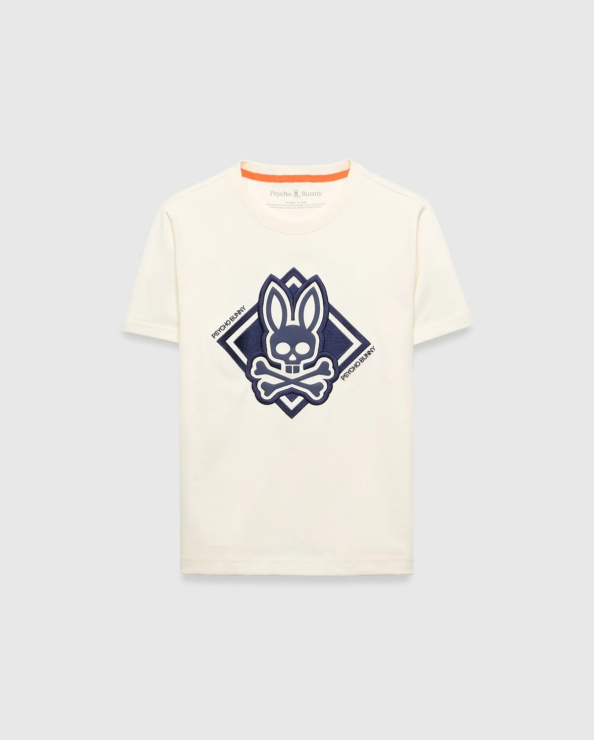Kids Tobias Graphic Tee, a classic fit cream jersey t-shirt with a large, textured navy blue Psycho Bunny skull and crossbones logo graphic inside a diamond on the chest, featuring orange neckline trim.
