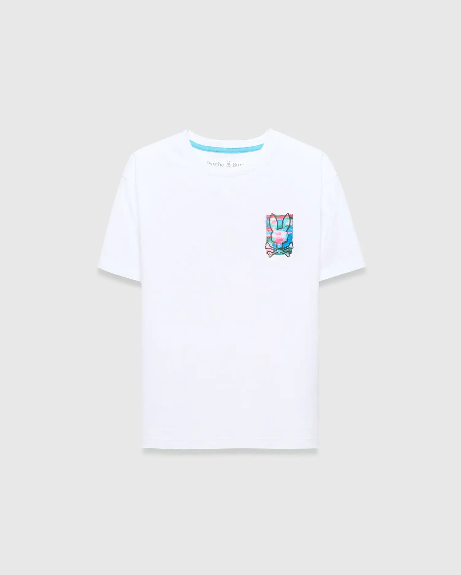 Kids Isaac Relaxed Fit Tee in crisp white jersey, featuring a vibrant, small graphic Psycho Bunny skull and crossbones logo print on the left chest with pink, blue, and green accents.