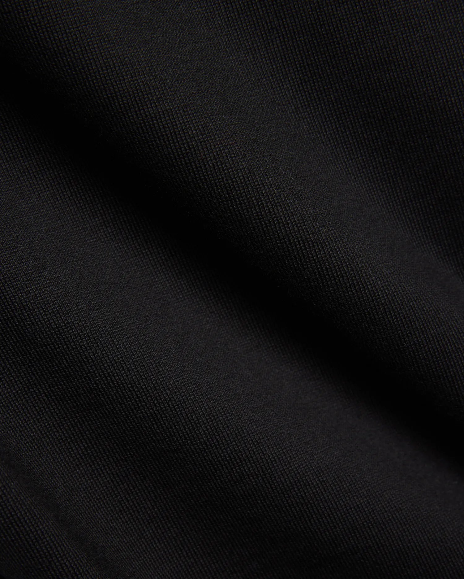Kids Duncan Relaxed Fit Tee, a premium black jersey tee featuring a soft, finely woven texture, embodying Psycho Bunny's refined streetwear comfort.
