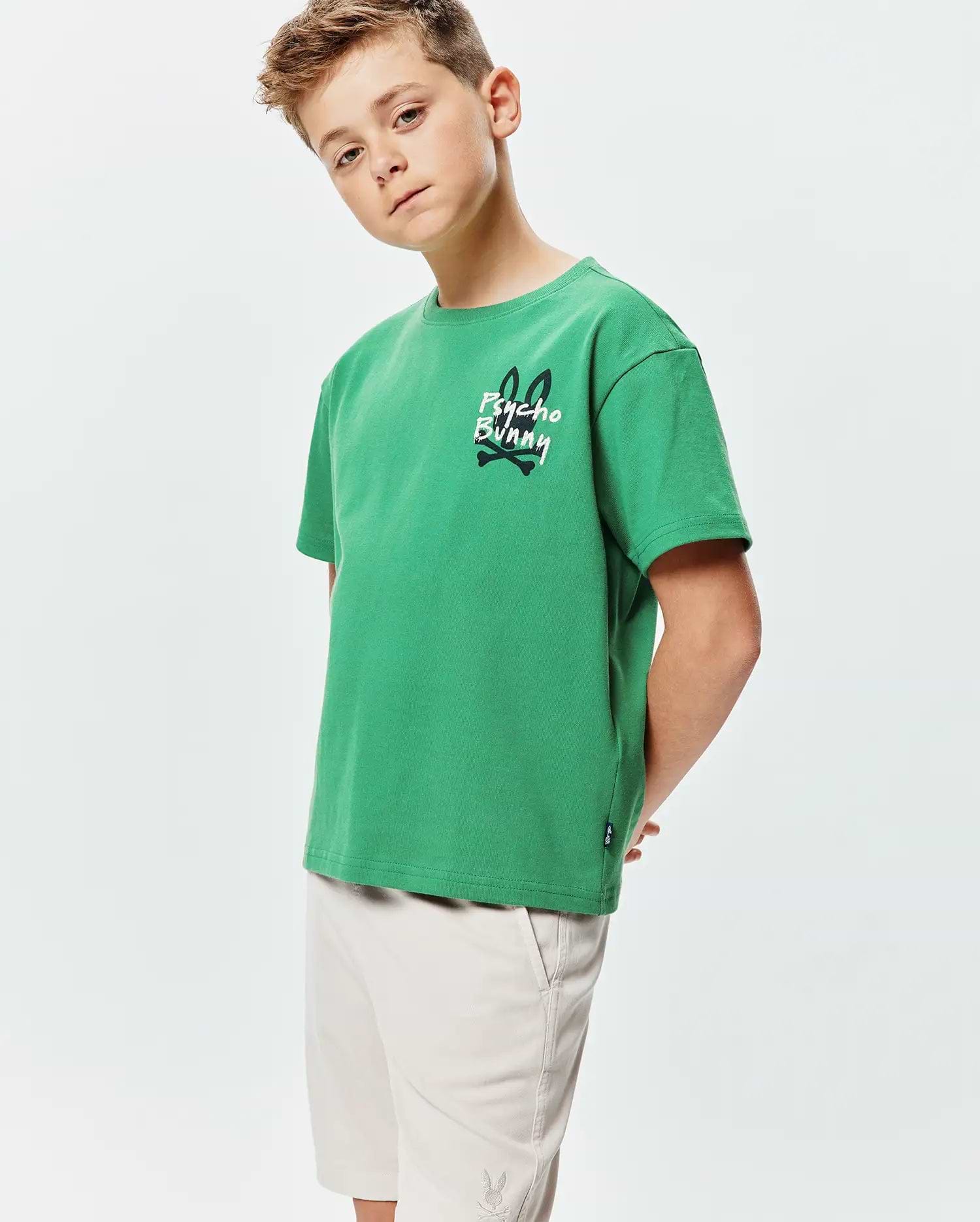 Kids Duncan Relaxed Fit Tee in vibrant green jersey, featuring a large white and black Psycho Bunny skull graphic on the left chest and a small woven logo tag on the hem.