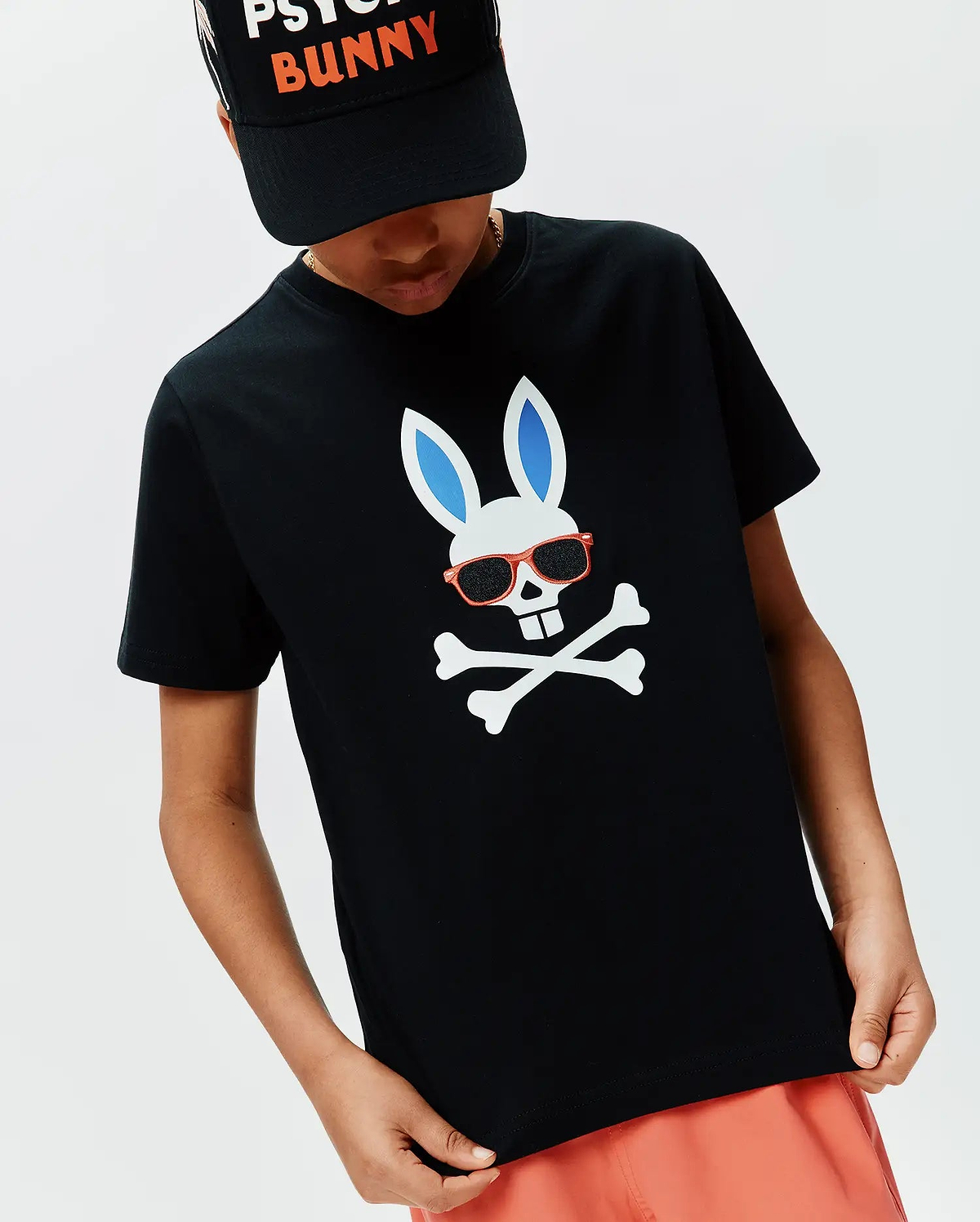 Kids Sunny Graphic Tee, black classic fit jersey t-shirt featuring a large central white bunny skull with blue ears, red sunglasses, and white crossbones graphic.