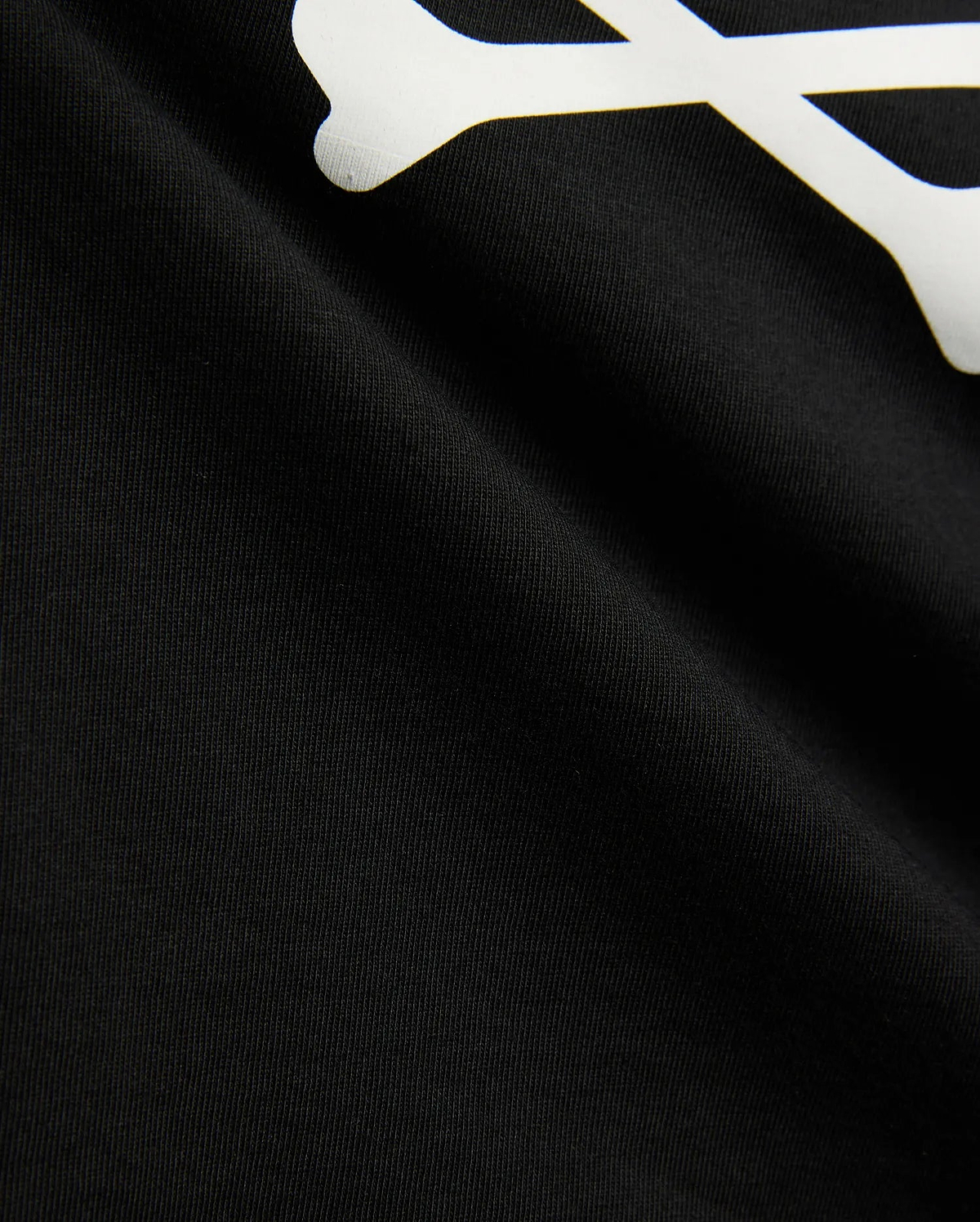 Kids Sunny Graphic Tee in black jersey knit, showcasing a large white graphic print of a bone, a key element of the iconic Psycho Bunny skull and crossbones logo.
