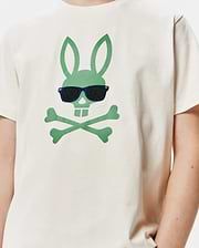 Kids Sunny Graphic Tee, a cream classic-fit jersey t-shirt featuring a large central green Psycho Bunny skull and crossbones logo wearing embroidered dark blue sunglasses with black lenses.