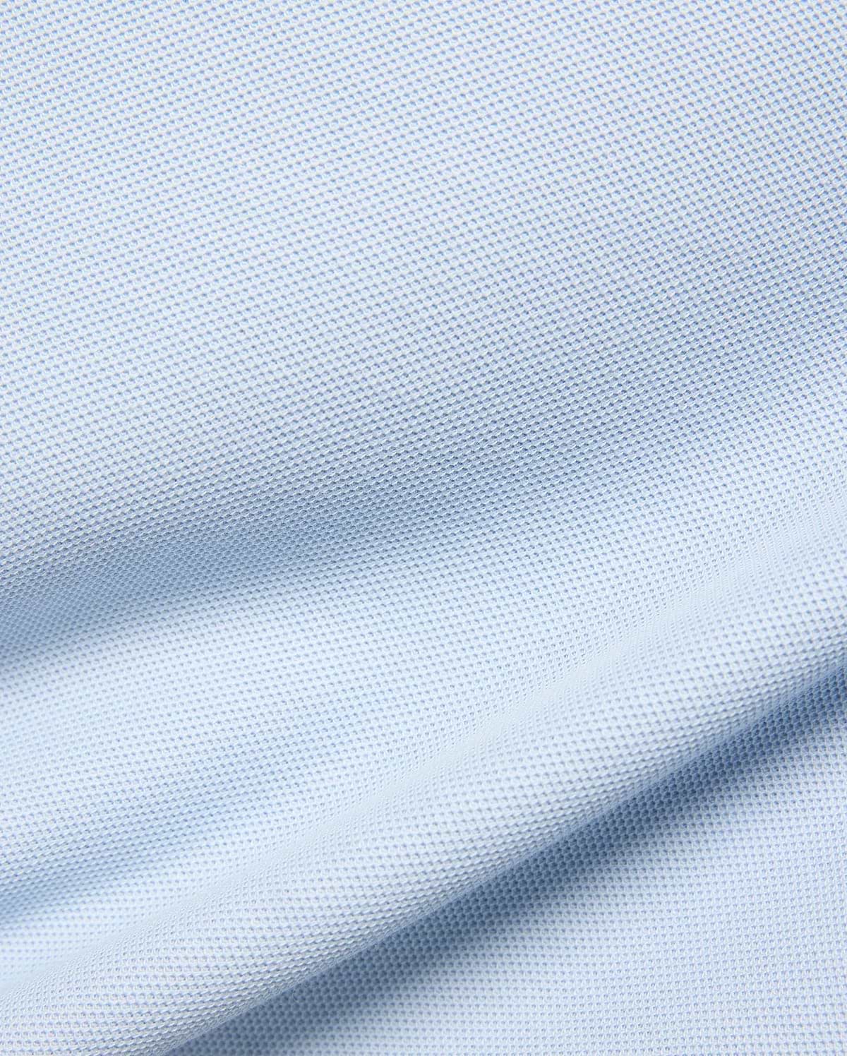 Kids Taylor Pique Tee in a soft, pale blue, featuring a finely textured, breathable pique knit fabric with gentle, flowing drapes and subtle shadows highlighting its classic weave. (5)