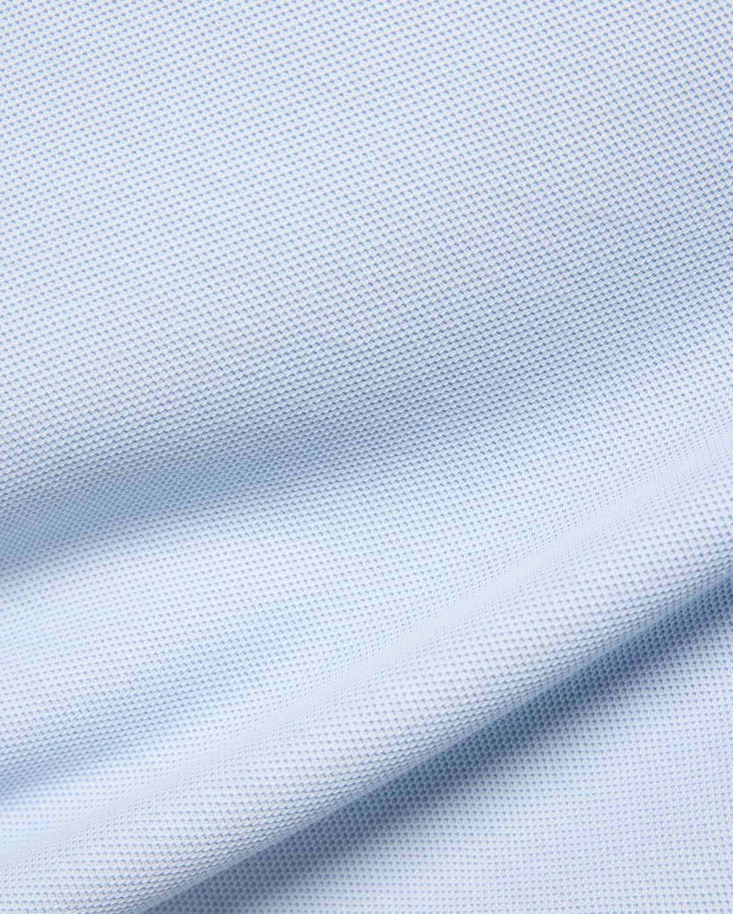 Kids Taylor Pique Tee in a soft, pale blue, featuring a finely textured, breathable pique knit fabric with gentle, flowing drapes and subtle shadows highlighting its classic weave. (5)