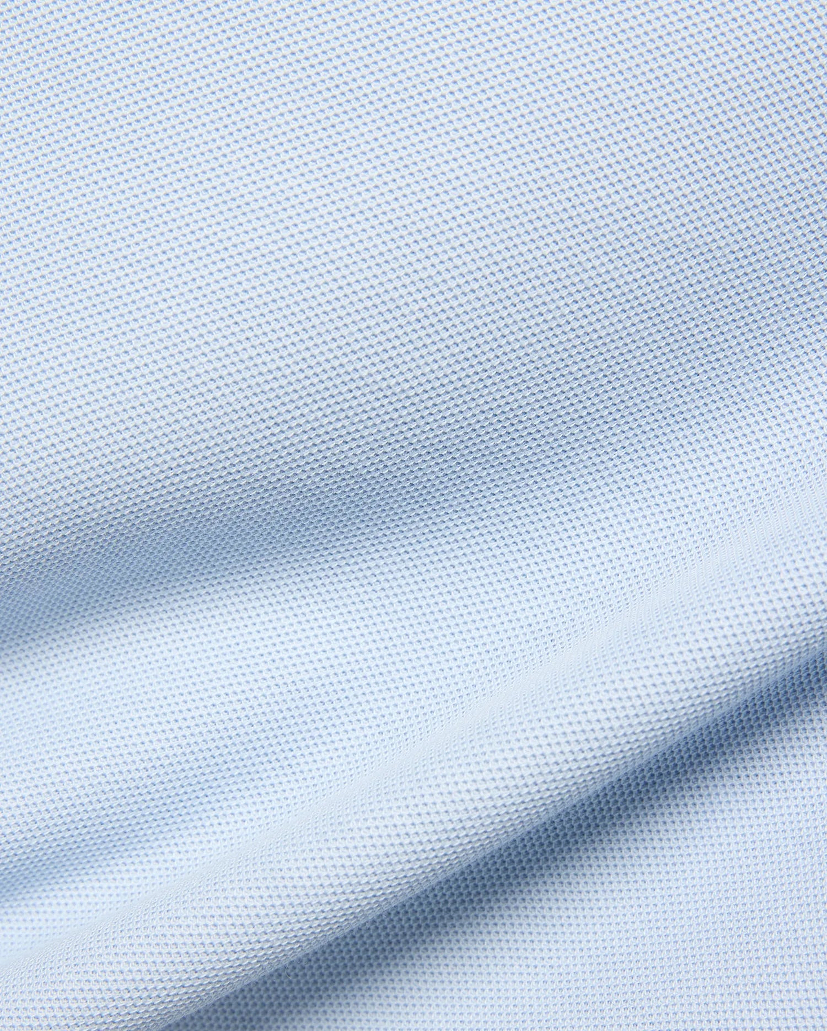 Kids Taylor Pique Tee in a soft, pale blue, featuring a finely textured, breathable pique knit fabric with gentle, flowing drapes and subtle shadows highlighting its classic weave. (5)