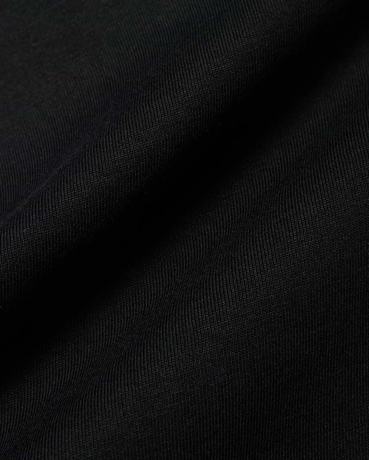 Premium black Kids Conan Back Graphic Tee, crafted from soft, finely ribbed jersey fabric, hinting at a bold back graphic for refined streetwear style.