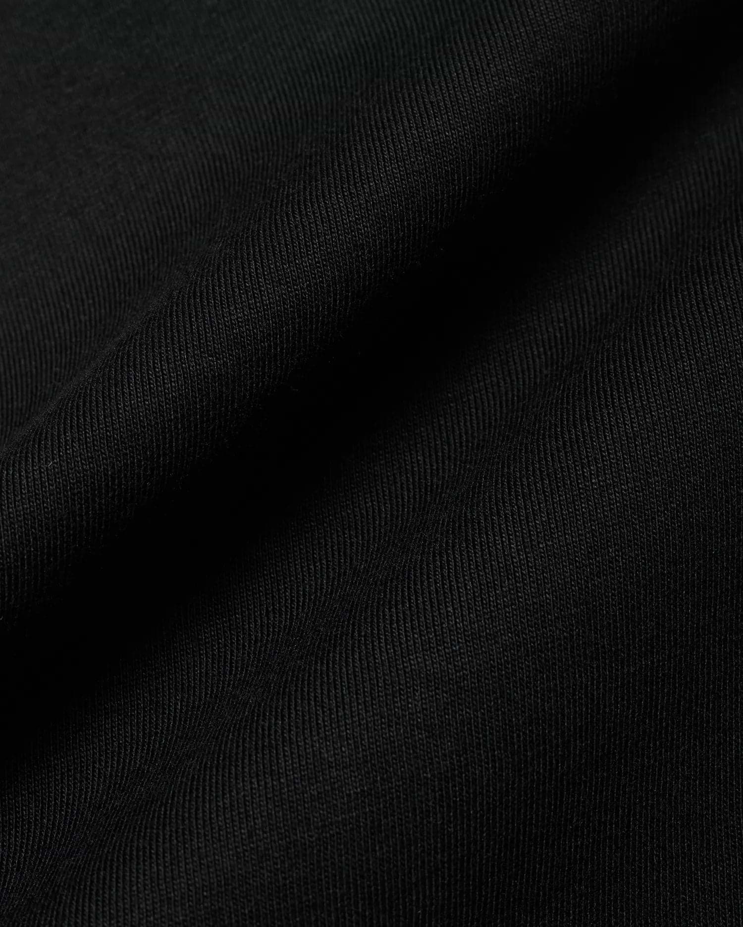 Premium black Kids Conan Back Graphic Tee, crafted from soft, finely ribbed jersey fabric, hinting at a bold back graphic for refined streetwear style.