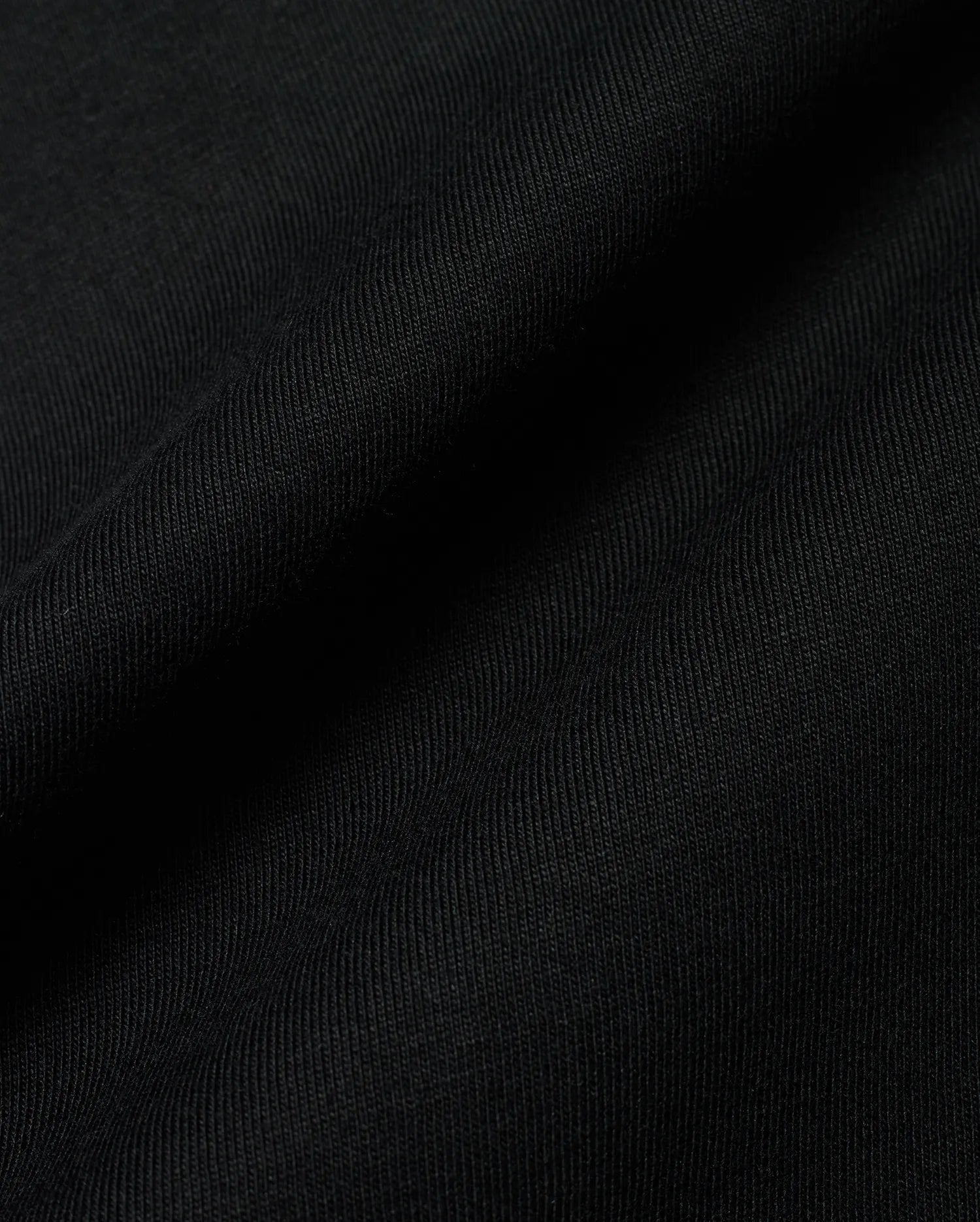 Premium black Kids Conan Back Graphic Tee, crafted from soft, finely ribbed jersey fabric, hinting at a bold back graphic for refined streetwear style.