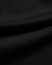 Premium black Kids Jaydon Wordmark Graphic Tee fabric, a soft, finely textured jersey knit with visible subtle ribbing and elegant draping folds, highlighting material quality.