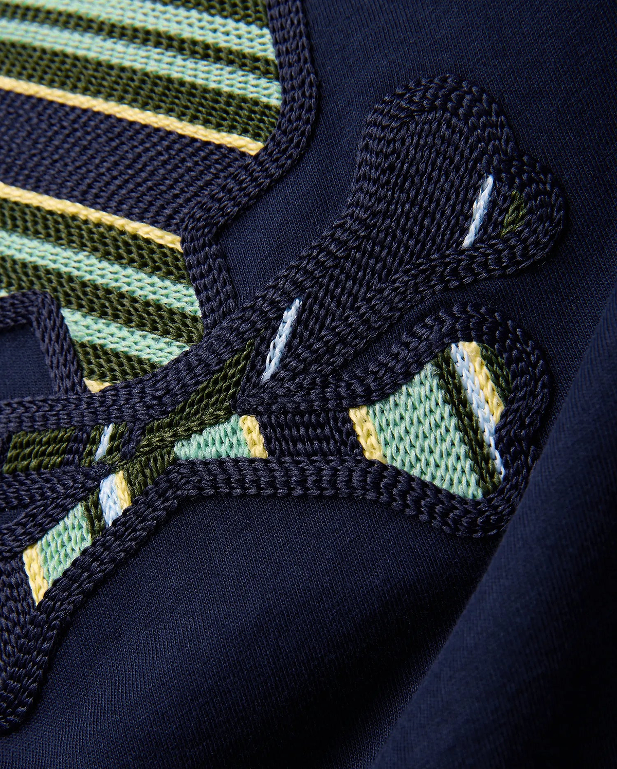 Kids Drew Embroidered Graphic Tee in classic navy jersey, showcasing a large, intricately textured graphic with bold green, yellow, light blue, and white striped embroidery.