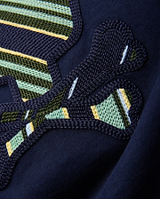 Kids Drew Embroidered Graphic Tee in classic navy jersey, showcasing a large, intricately textured graphic with bold green, yellow, light blue, and white striped embroidery.