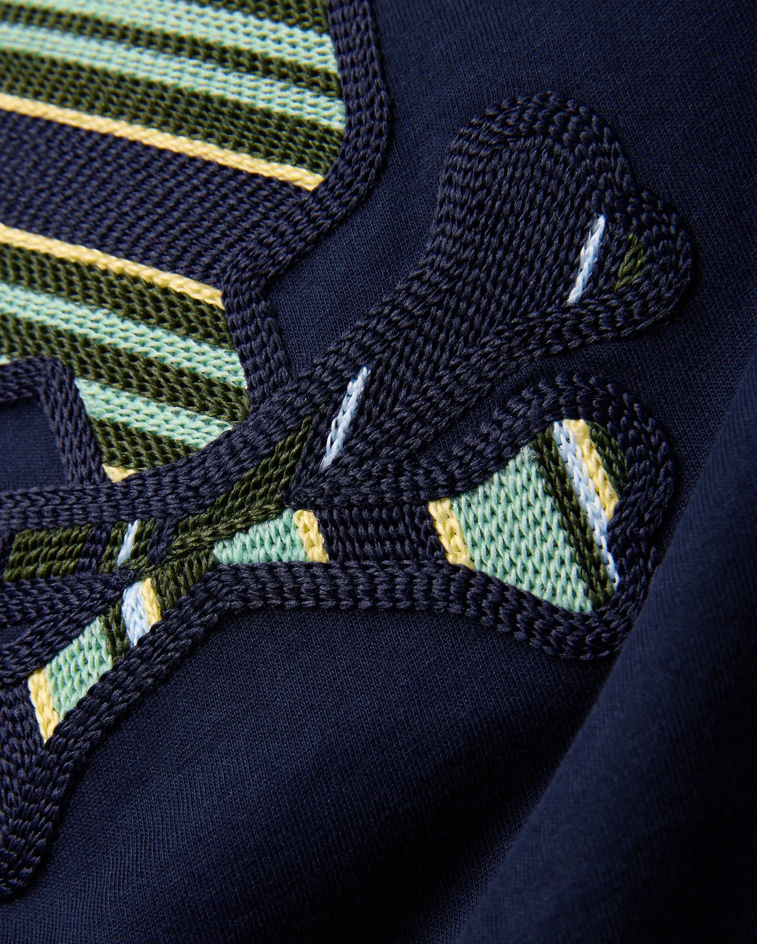 Kids Drew Embroidered Graphic Tee in classic navy jersey, showcasing a large, intricately textured graphic with bold green, yellow, light blue, and white striped embroidery.