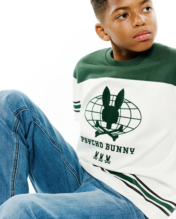 Kids Mike Graphic Jersey Tee, white and dark green color block with a large central Psycho Bunny globe graphic, text, and three small bunny skull logos, plus green and black sleeve stripes.