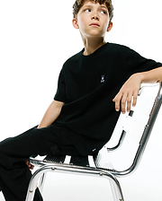 Black Kids Maxton Waffle Tee with a classic fit, featuring a subtle waffle knit texture and a small embroidered white Psycho Bunny skull logo on the left chest.