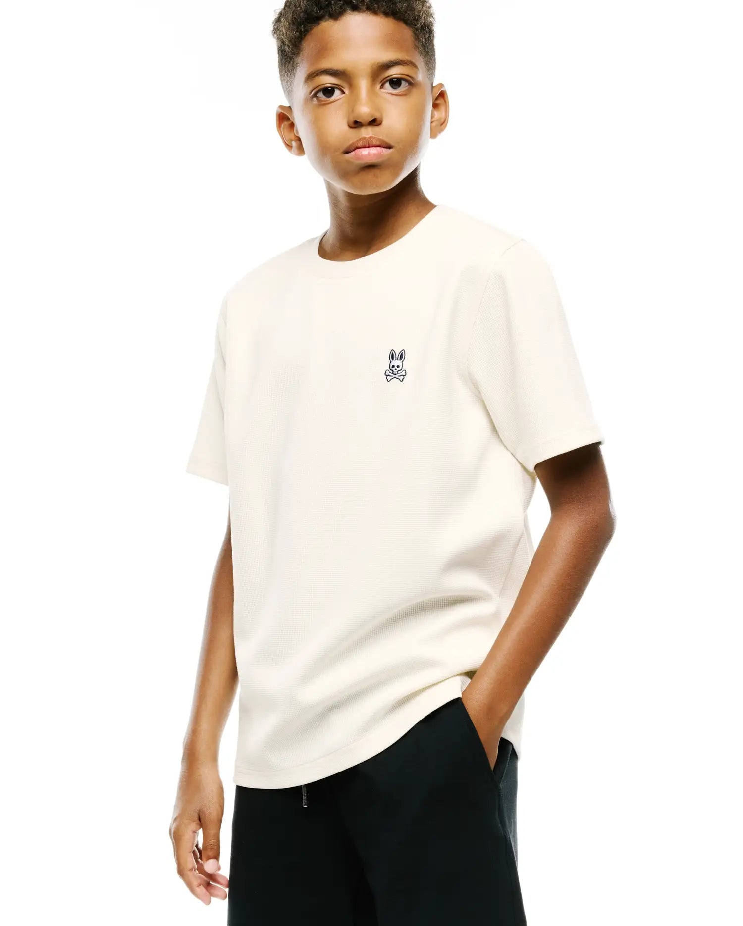 Kids Maxton Waffle Tee in cream, a classic fit t-shirt featuring a textured waffle knit fabric and a small, embroidered black and white Psycho Bunny skull logo on the left chest.