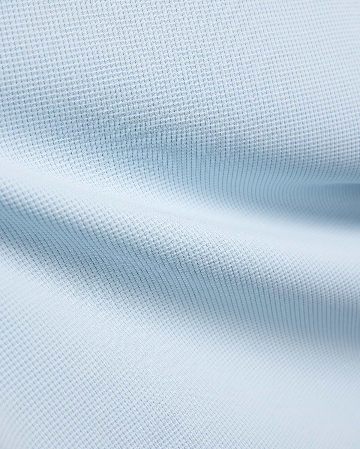 Kids Maxton Waffle Tee fabric in a soft sky blue, showcasing its distinctive raised waffle knit texture with subtle folds, ideal for comfortable, refined streetwear.