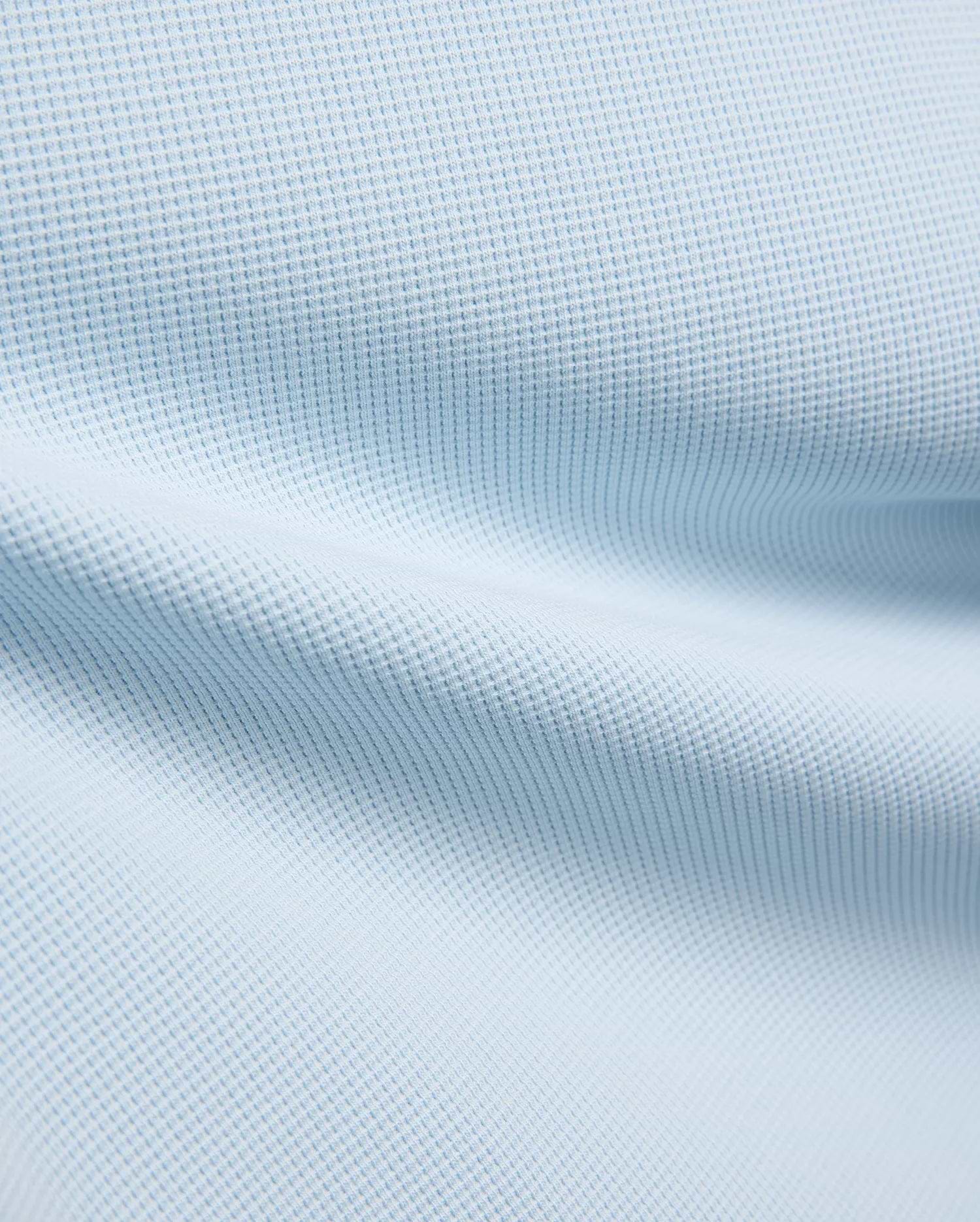 Kids Maxton Waffle Tee fabric in a soft sky blue, showcasing its distinctive raised waffle knit texture with subtle folds, ideal for comfortable, refined streetwear.