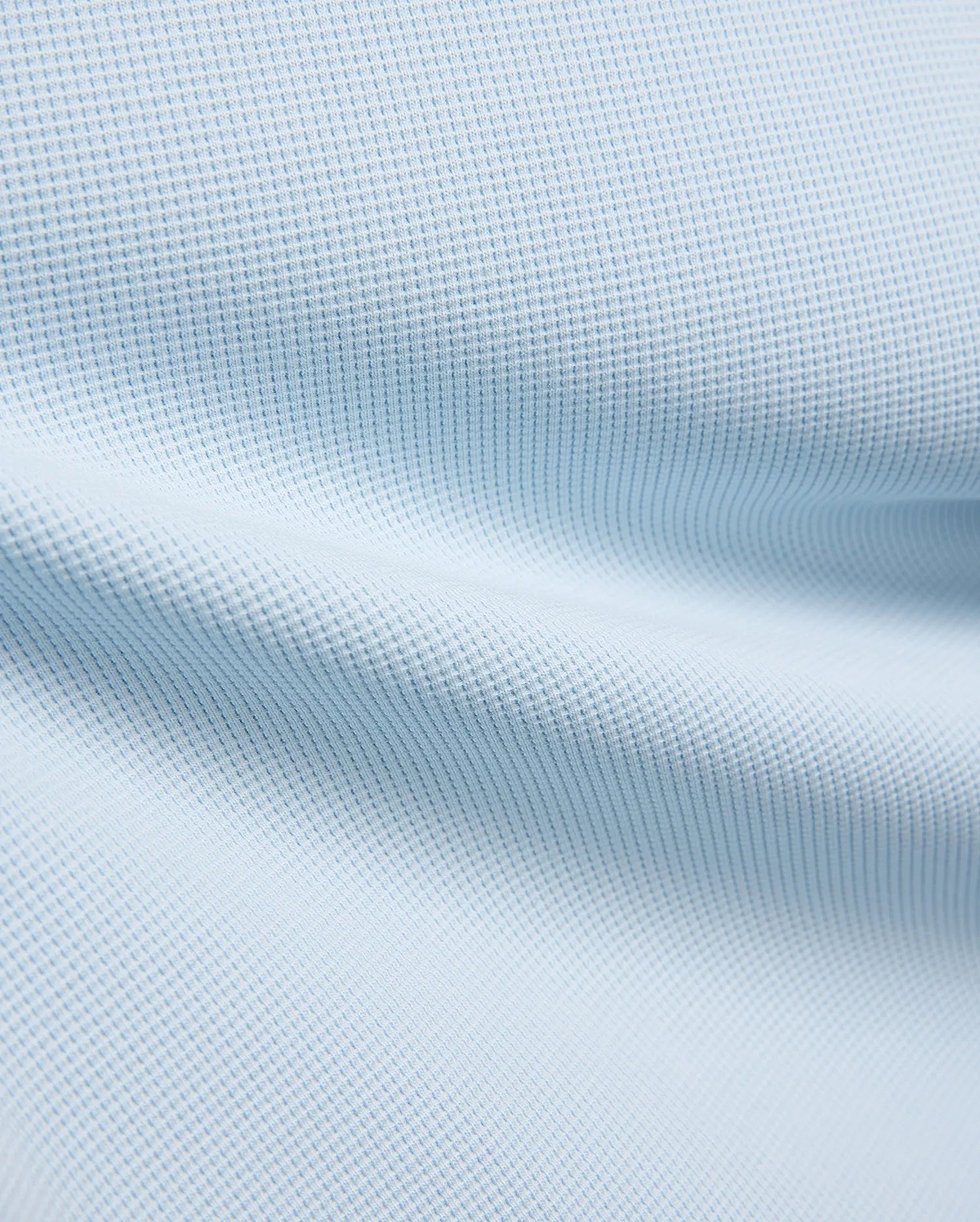 Kids Maxton Waffle Tee fabric in a soft sky blue, showcasing its distinctive raised waffle knit texture with subtle folds, ideal for comfortable, refined streetwear.